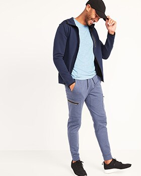 A model wears a blue full-zip Dynamic Fleece hoodie, light green top and light blue fleece cargo jogger sweatpants