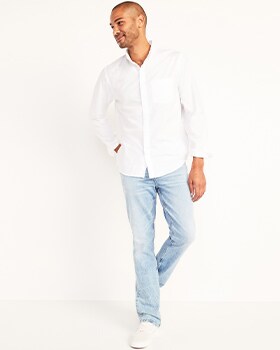 A model wears Boot-Cut style jeans and a white button-up shirt