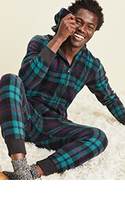 A male model wearing green and black flannel pajama set.