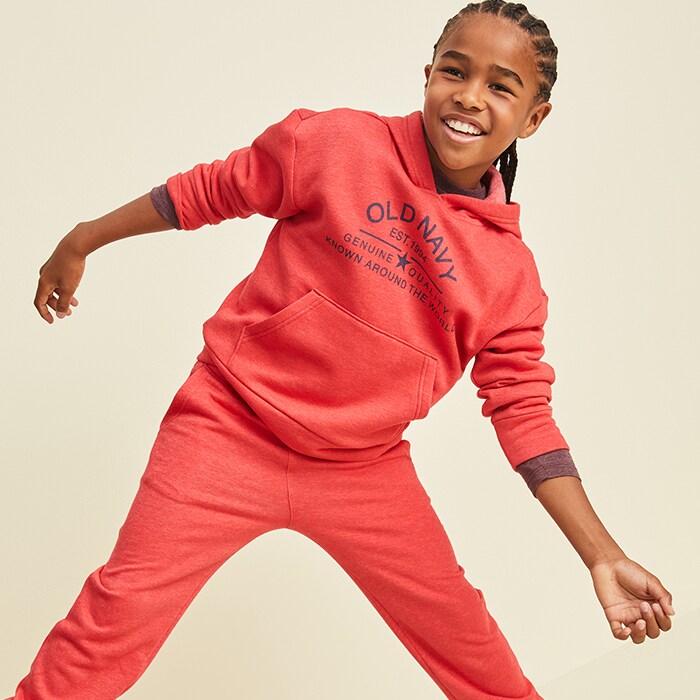 A male model wearing matching red hoodie and sweatpants.