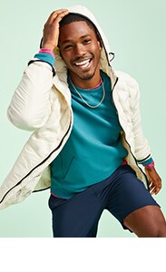 A male model wearing green fleece, dark blue short and white active jacket.