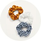 Three silk scrunchies in different colors and patterns.