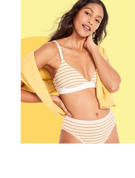 A female model wearing a matching striped underwear and bra set