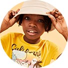 A young model wearing a graphic t-shirt and a light colour bucket hat.