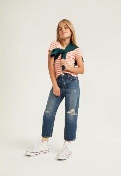 A female model wears Straight style jeans with a white & orange horizontal stripe short sleeve top.