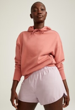 Female model wearing dynamic fleece pullover hoodie and short.