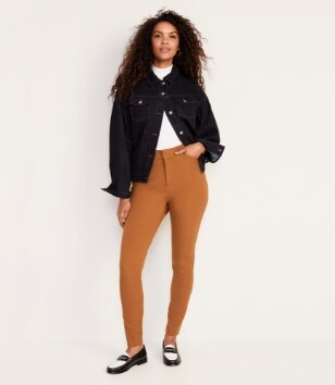 A female model wearing orange colored Pixie Skinny style pants