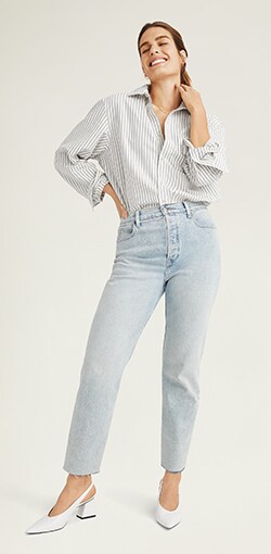 Model in very light wash straight leg jeans with relaxed fit at hips.