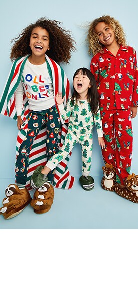 Three models wearing Old Navy jingle jammies in various colors and prints.