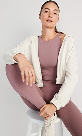 A female model wears rose colored Extra High-Waisted PowerChill Crossover 7/8-Length Leggings & matching activewear top.