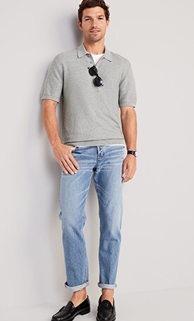 A male model wears light washed jeans