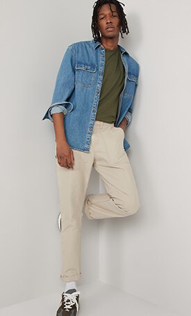 A male model wears cream colored Straight Non-Stretch Canvas Workwear Pants & a denim shirt