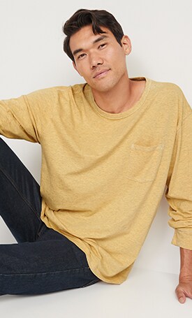 A male model wears a yellow colored Slub-Knit Long-Sleeve Pocket T-Shirt