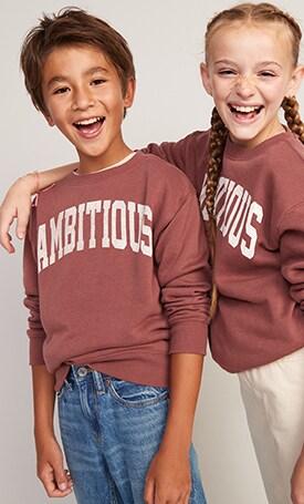 A boy and a girl dressed in matching longsleeve graphic print tshirts.