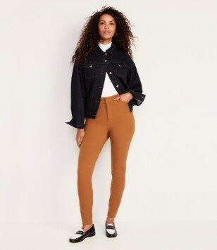 A female model wearing orange coloured Pixie Skinny style pants