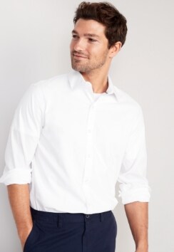 A male model wears a white Signature button-up long-sleeve shirt.