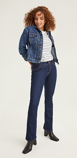 Boot-cut navy blue jeans, a striped top, and dark denim jacket.