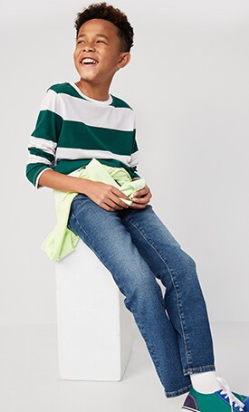 A male model dressed in striped long sleeve shirt and wow-straight jean.