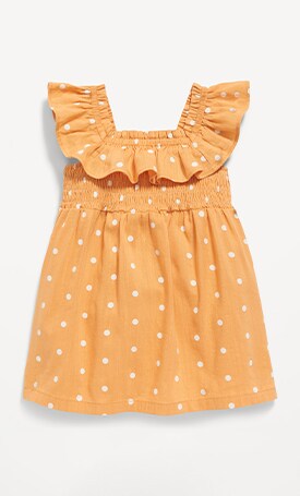 Image features orange polka dot print dress for baby.