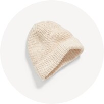 Image features unisex beige beanie cap for baby.