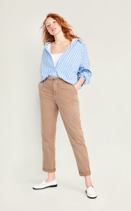 A female model wearing light brown straight style pants