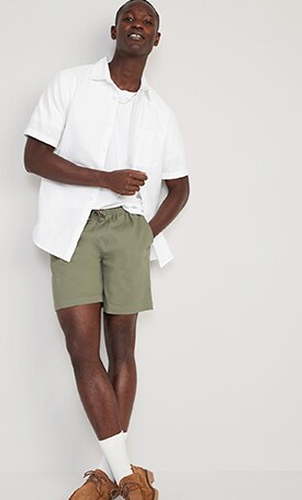 A male model wears  dark green Pull-On Chino Jogger Shorts for Men -- 7-inch inseam