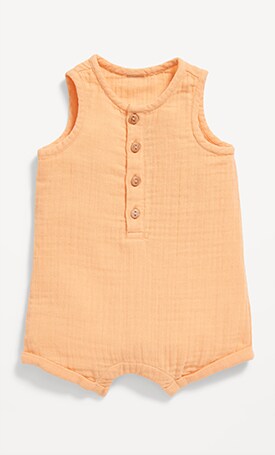 Image features orange polka dot print dress for baby.