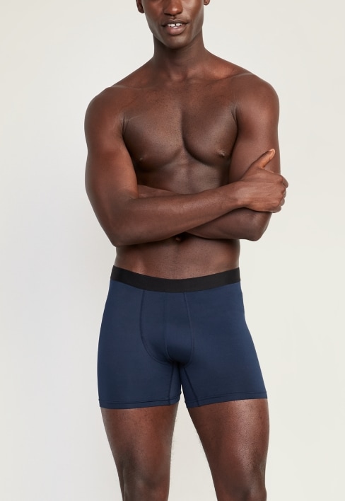 A male model wearing dark blue tech boxer brief style underwear