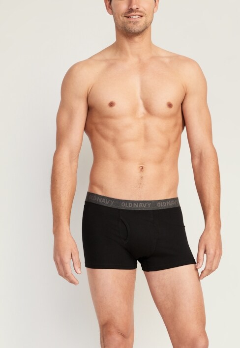 A male model wearing black trunk style underwear