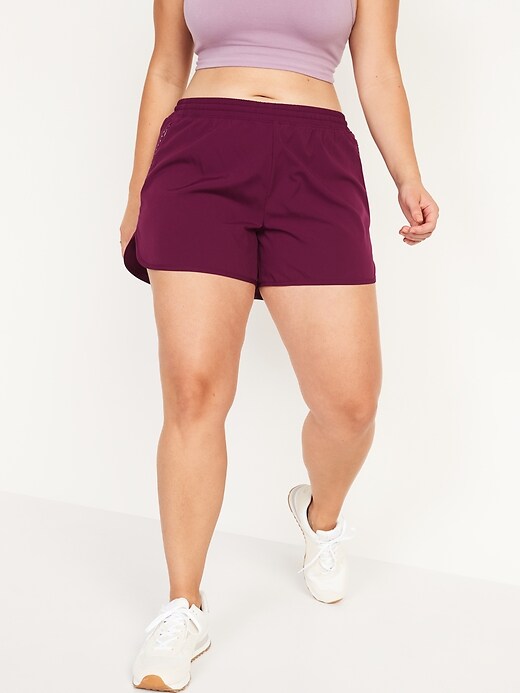 Image number 1 showing, Mid-Rise StretchTech Dolphin-Hem Run Shorts for Women -- 4-inch inseam