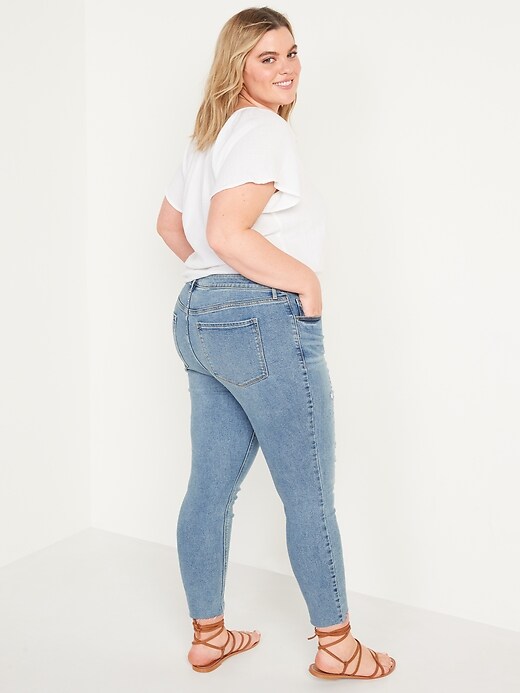 Image number 8 showing, Mid-Rise Rockstar Super-Skinny Ripped Cut-Off Ankle Jeans for Women