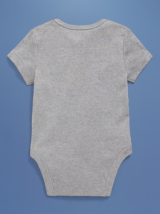 View large product image 2 of 5. Old Navy x Disney© Short-Sleeve Flag Logo-Graphic Bodysuit for Baby